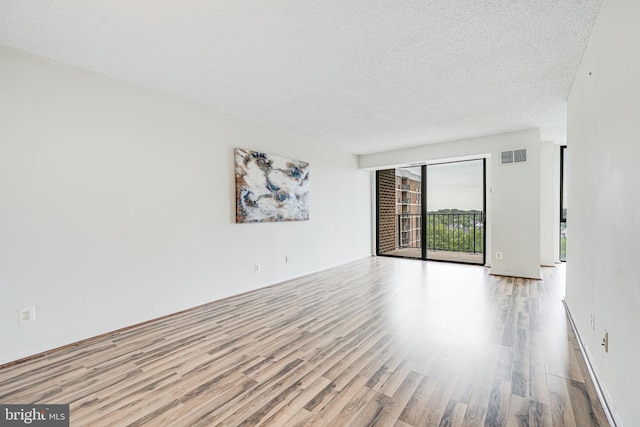 2311 Pimmit Dr Unit 1102, Falls Church, VA 22043 - unfurnished room with wood finished floors and a textured ceiling