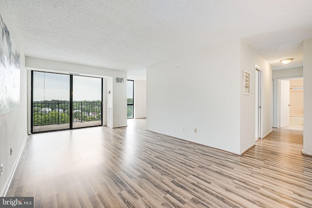 2311 Pimmit Dr Unit 1102, Falls Church, VA 22043 - unfurnished room with light wood-type flooring and a textured ceiling