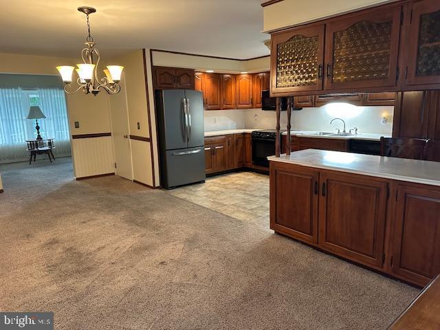 355 George St, Hanover, PA 17331 - kitchen featuring freestanding refrigerator, range, a chandelier, light countertops, and decorative light fixtures