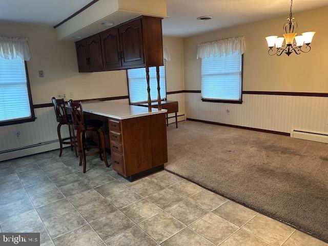 355 George St, Hanover, PA 17331 - kitchen with a wainscoted wall, plenty of natural light, a baseboard radiator, a chandelier, and a baseboard heating unit