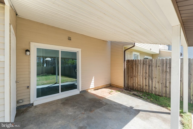 view of patio / terrace with a carport and fence
