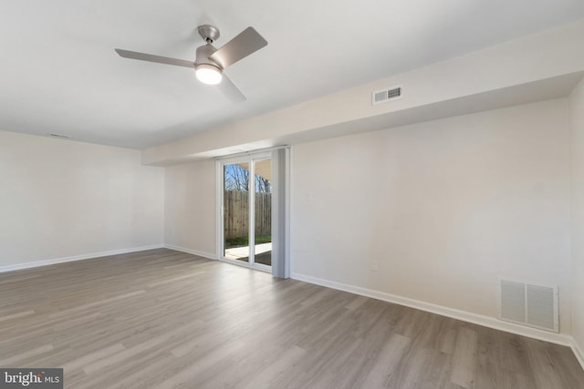 spare room featuring visible vents and wood finished floors