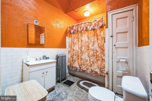 4910 N Hutchinson St, Philadelphia, PA 19141 - bathroom featuring radiator heating unit, wainscoting, tile walls, and toilet