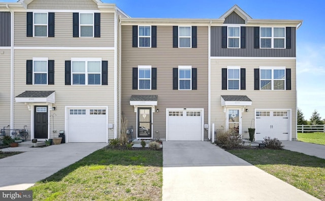 view of property featuring driveway and an attached garage