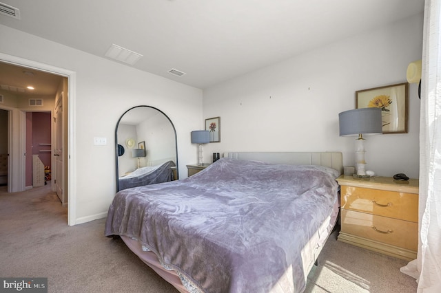 carpeted bedroom with visible vents and baseboards