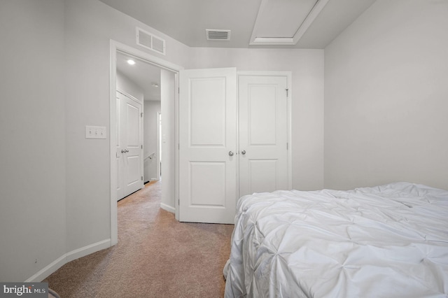 bedroom featuring light carpet, visible vents, baseboards, and a closet