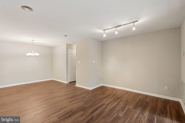 2816 Lee Oaks Pl Unit 102, Falls Church, VA 22046 - spare room with rail lighting, dark wood-type flooring, a chandelier, and baseboards