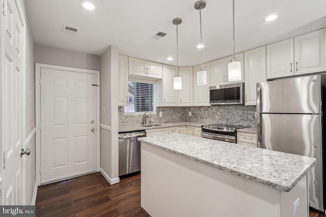 2816 Lee Oaks Pl Unit 102, Falls Church, VA 22046 - kitchen featuring tasteful backsplash, a sink, appliances with stainless steel finishes, dark wood-style floors, and a center island