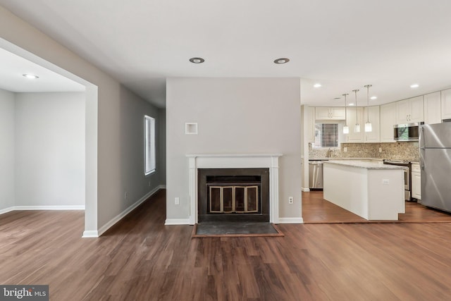 2816 Lee Oaks Pl Unit 102, Falls Church, VA 22046 - kitchen with backsplash, a kitchen island, appliances with stainless steel finishes, and dark wood finished floors