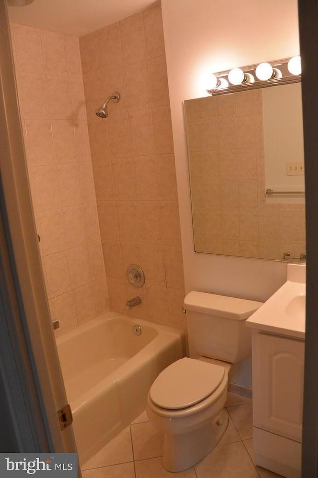 bathroom featuring toilet, shower / bathing tub combination, tile patterned flooring, and vanity