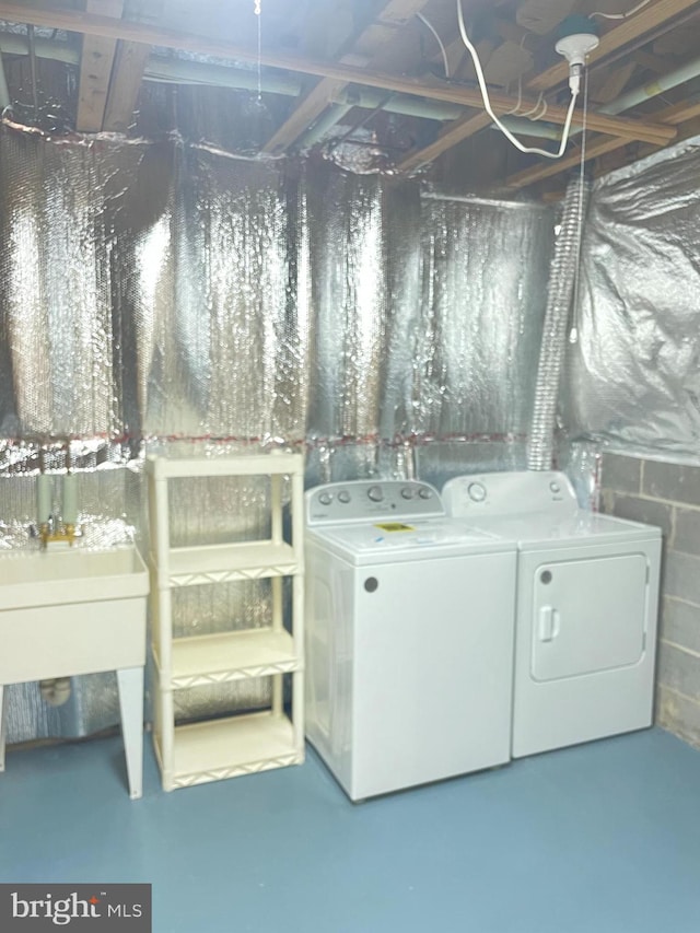 washroom with separate washer and dryer and laundry area
