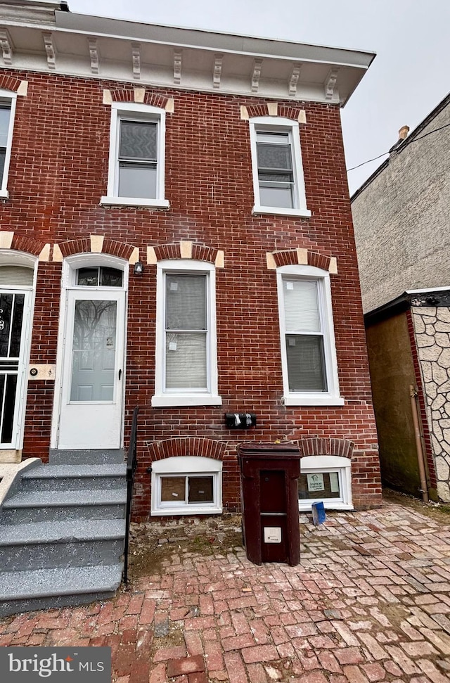 view of front of home featuring brick siding