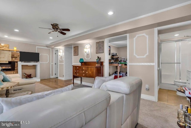 living room with baseboards, a ceiling fan, recessed lighting, and a fireplace