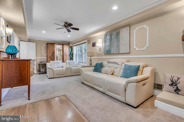 living area featuring recessed lighting, visible vents, light wood-type flooring, and a ceiling fan