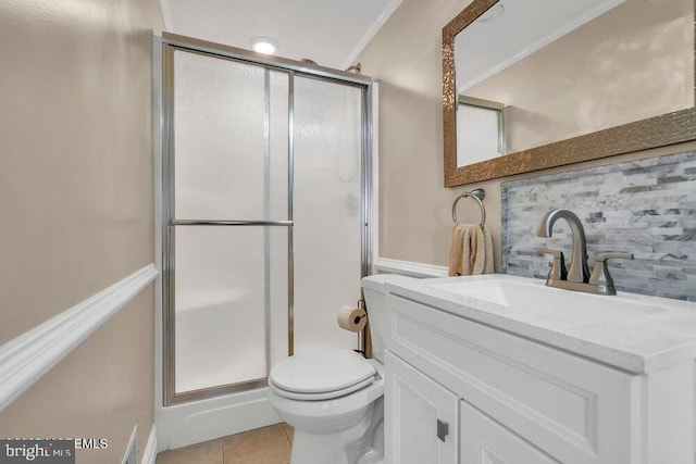 bathroom featuring vanity, tile patterned flooring, backsplash, toilet, and a shower stall