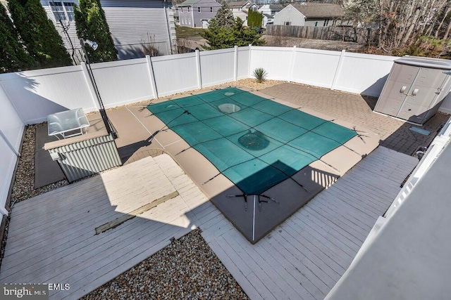 view of pool with a fenced backyard, a wooden deck, and a fenced in pool