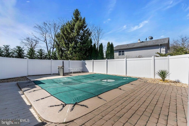 view of swimming pool featuring a fenced backyard, a fenced in pool, and a patio area