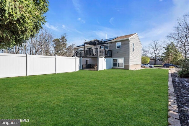 view of yard with a wooden deck and fence