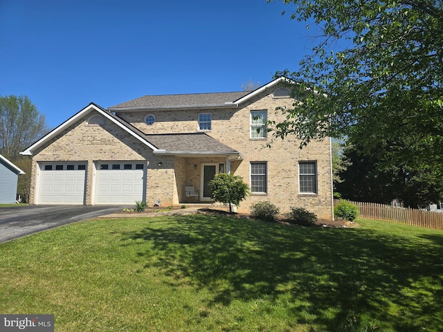 traditional home with a front lawn, aphalt driveway, fence, brick siding, and an attached garage