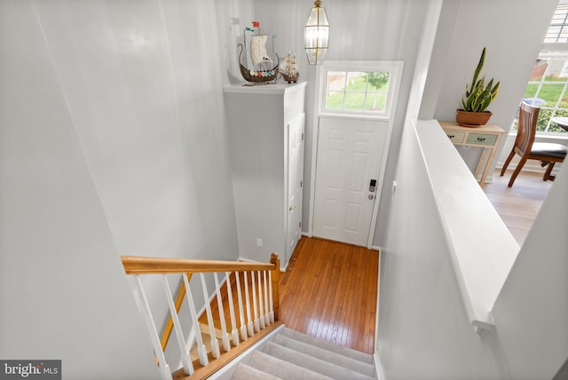 staircase with baseboards and wood finished floors
