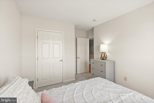 bedroom featuring baseboards and light colored carpet
