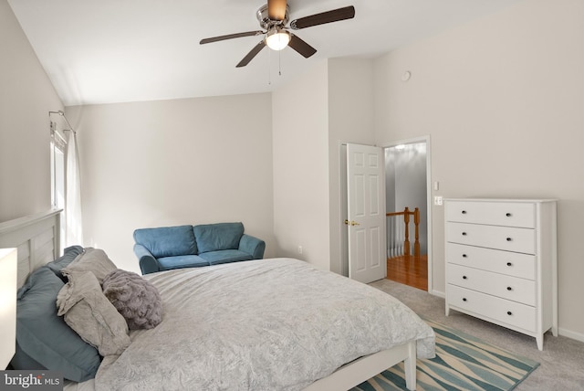bedroom featuring ceiling fan, high vaulted ceiling, and light colored carpet