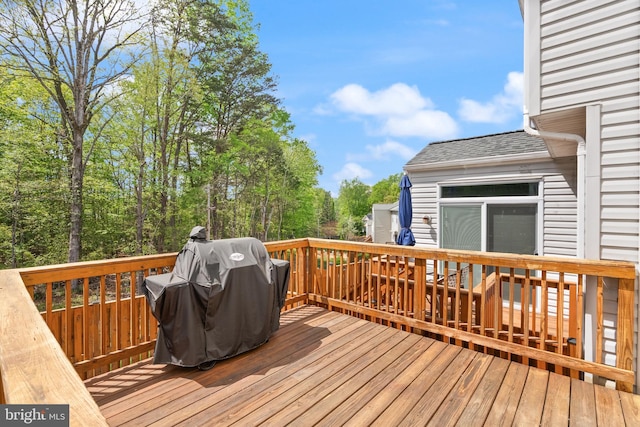 wooden terrace featuring a grill