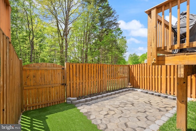 exterior space with fence, a gate, and a patio