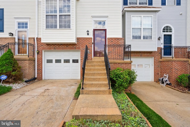 view of front facade with a garage, brick siding, and concrete driveway