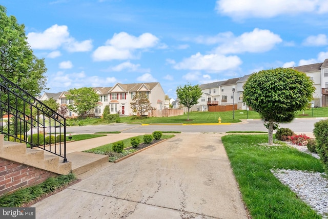 view of community featuring a lawn and a residential view