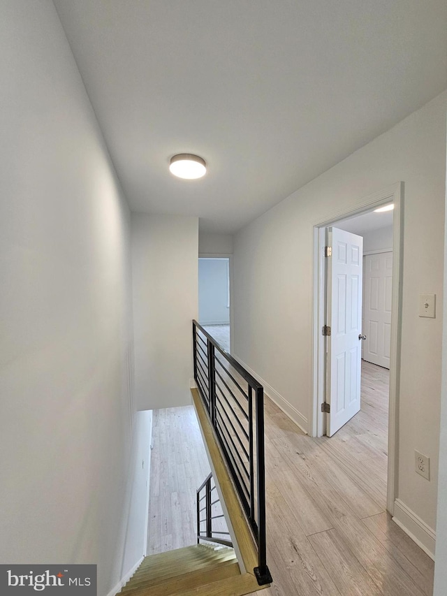 stairs with baseboards and wood finished floors