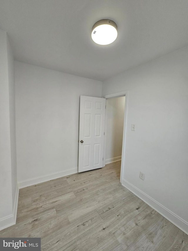 unfurnished room featuring light wood-style floors and baseboards