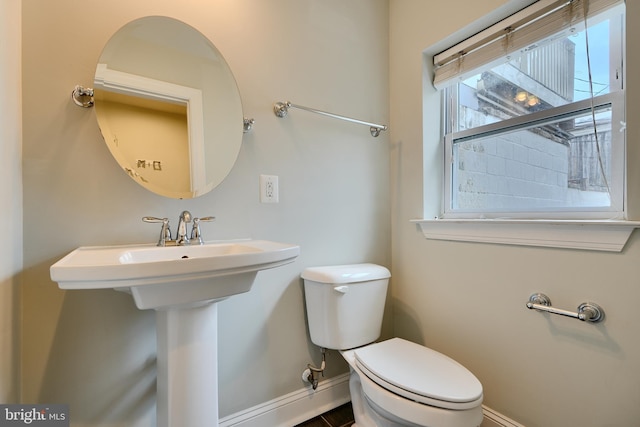 bathroom with toilet and baseboards