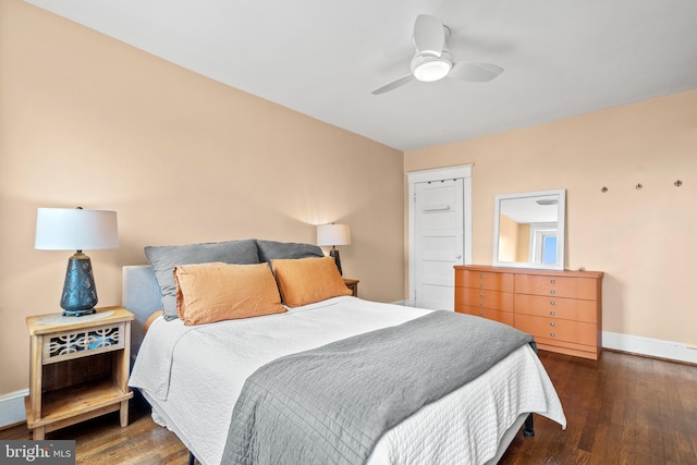bedroom featuring ceiling fan, baseboards, and dark wood finished floors