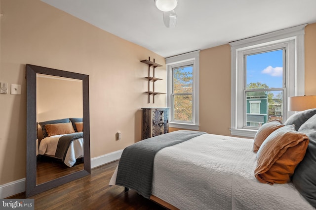 bedroom featuring dark wood-type flooring and baseboards