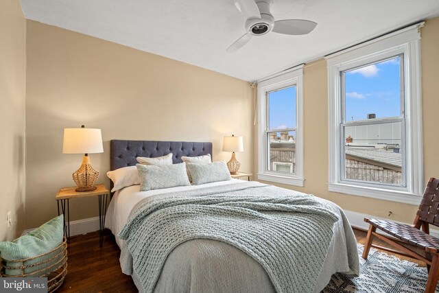 bedroom with wood finished floors, ceiling fan, and baseboards