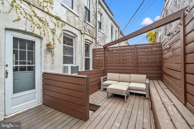 wooden deck with an outdoor living space