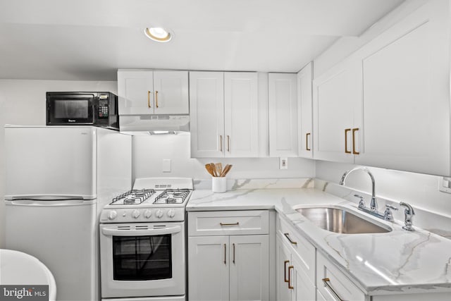 kitchen with white appliances, white cabinetry, light stone countertops, under cabinet range hood, and a sink