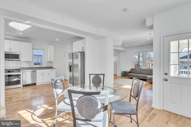 dining room featuring recessed lighting and light wood-type flooring