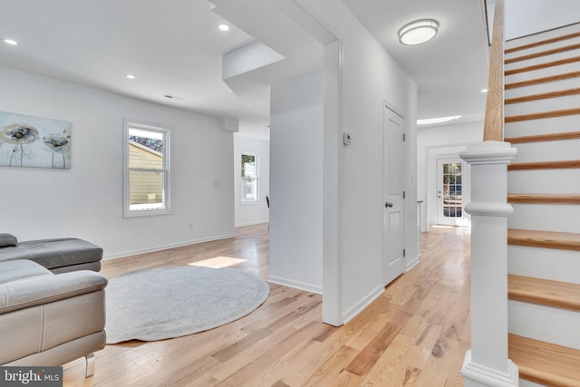 interior space featuring a wealth of natural light, light wood-style floors, and stairs