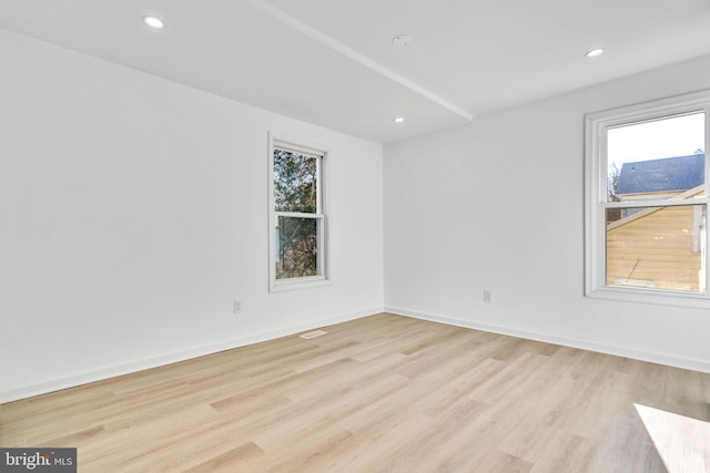empty room with baseboards, recessed lighting, and light wood-type flooring