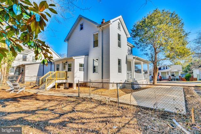 exterior space featuring fence and a chimney