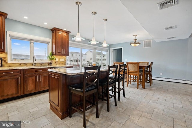 823 Forepeak Dr, Forked River, NJ 08731 - kitchen with a sink, visible vents, backsplash, and a kitchen breakfast bar