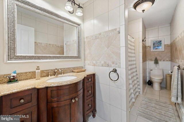823 Forepeak Dr, Forked River, NJ 08731 - full bath with a shower with shower curtain, toilet, tile walls, vanity, and tile patterned floors