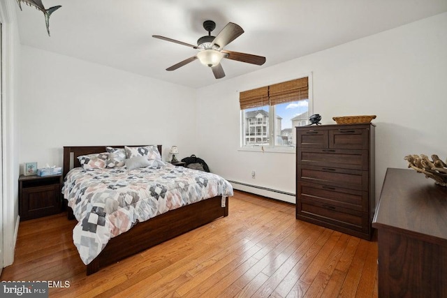 823 Forepeak Dr, Forked River, NJ 08731 - bedroom with a baseboard radiator, light wood finished floors, and ceiling fan