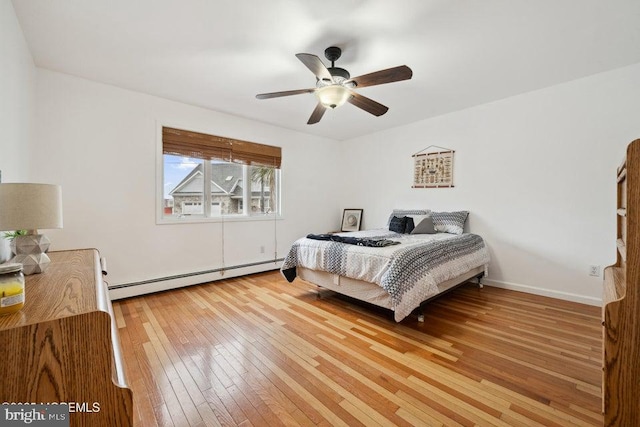 823 Forepeak Dr, Forked River, NJ 08731 - bedroom with ceiling fan, baseboards, hardwood / wood-style floors, and a baseboard heating unit