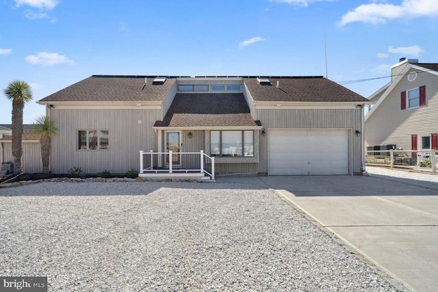 823 Forepeak Dr, Forked River, NJ 08731 - view of front of home with fence, an attached garage, a shingled roof, and concrete driveway
