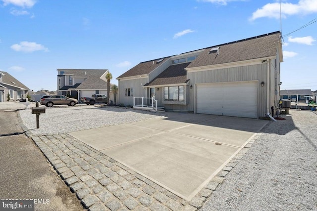823 Forepeak Dr, Forked River, NJ 08731 - view of front of house with a shingled roof, concrete driveway, and a garage
