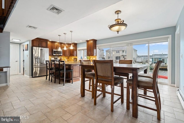 823 Forepeak Dr, Forked River, NJ 08731 - dining area with stone finish floor, baseboards, visible vents, and plenty of natural light