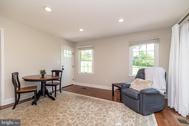 living area with wood finished floors, baseboards, and recessed lighting